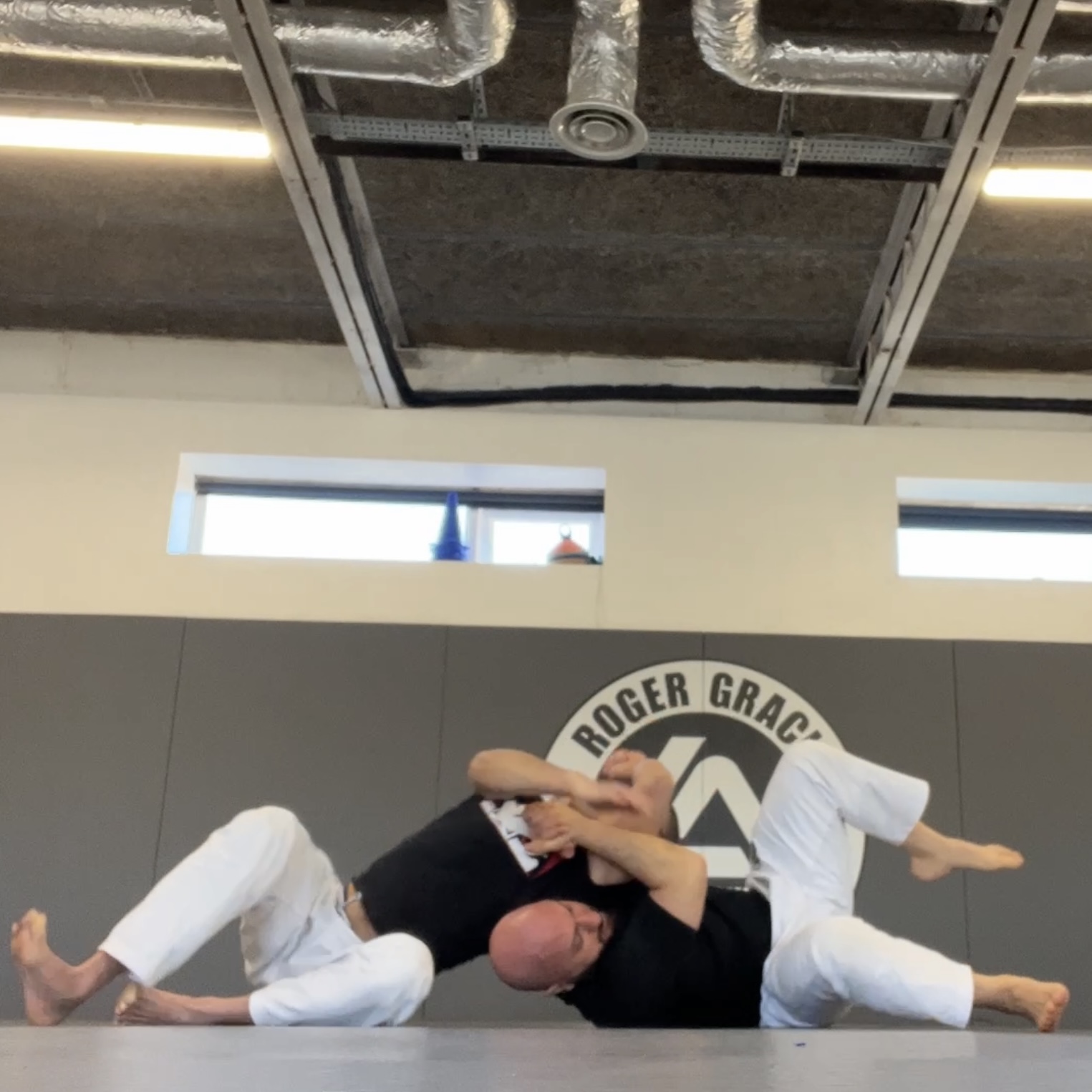 Olgun Tiltay learning basics of grappling from Chris Ong [2nd Dan] BJJ Coach at Roger Gracie Academy